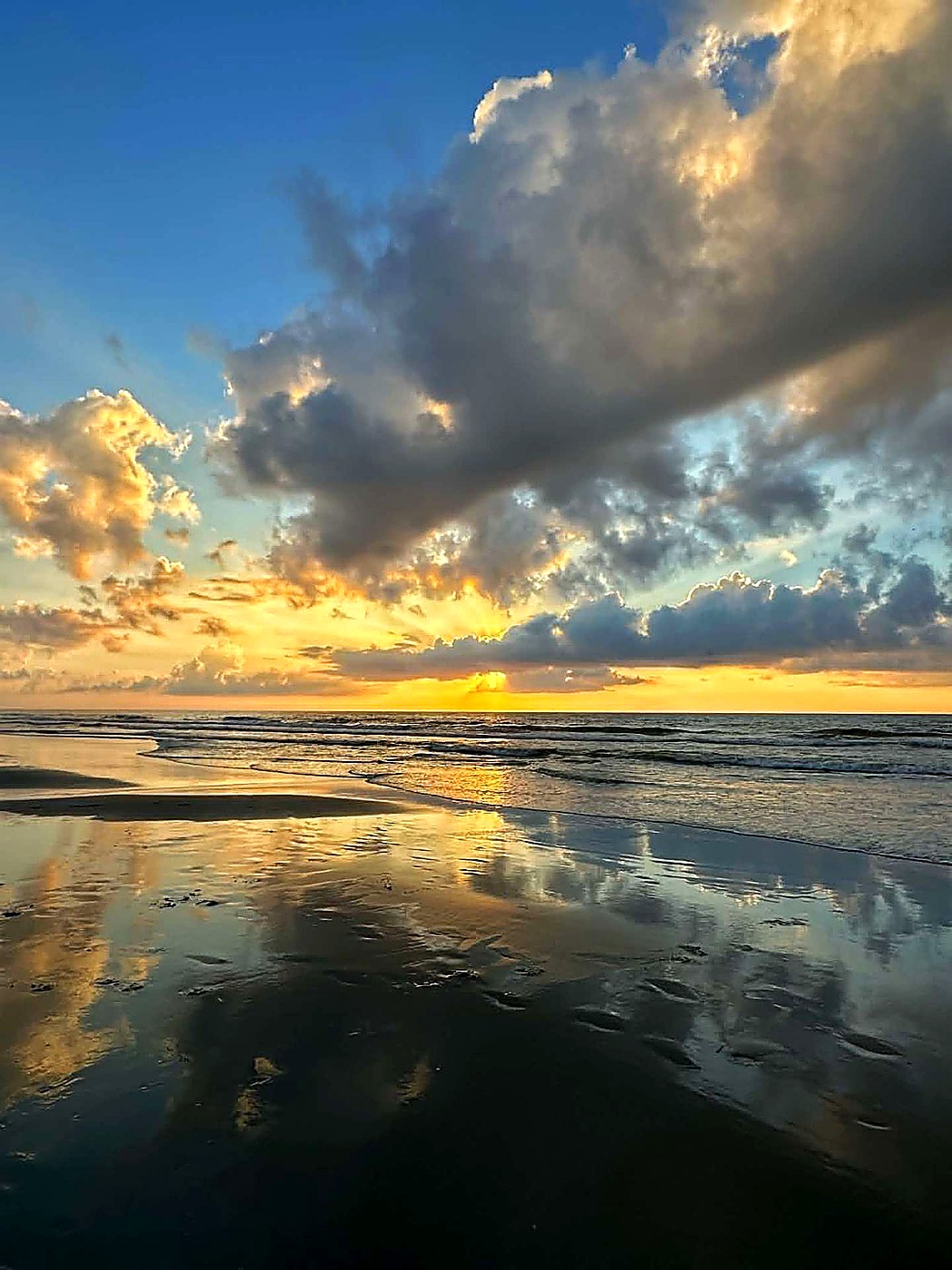 Low tide reflections at sunrise on Surfside Beach